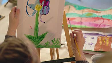 Kids interest group art class girl painting flower