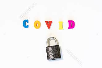 Closed lock with word COVID made with letter board. Concept of country closed borders. Coronavirus is a pandemic virus originating