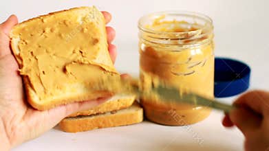 Girl makes a peanut butter sandwich for breakfast