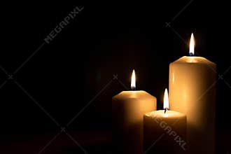 Christmas advent candle light in church with blurry golden bokeh for religious ritual, spiritual zen meditation, peaceful mind