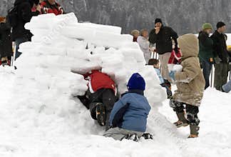 Kids building an igloo (snow house)