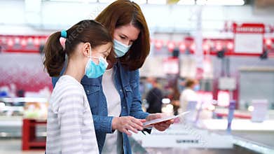 Family buying meat in supermarket during COVID