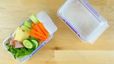 Making healthy salad school lunch boxes, time lapse.