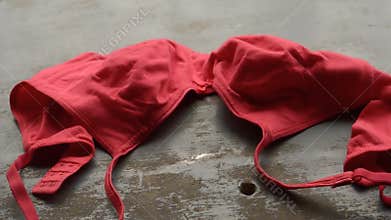 Red bra on rustic metallic floor. Romantic passion female lingerie. Sexy fashion background. Still life video footage