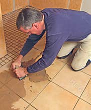 Man grouting a ceramic tile floor