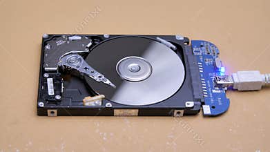 Work of hacked open hard drive inside. Hacker breaks sensitive data from a hard drive. Repair hard disk drive