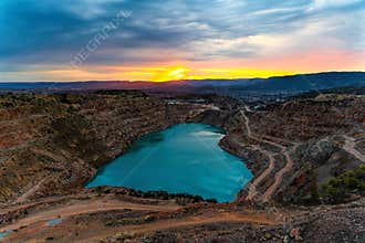 Sunrise over the blue quarry lake in the shape of a heart. Limestone fluxing of Kadykovo quarry, Balaklava, Crimea. A