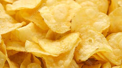 Golden potato chips rotating close up