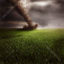 Tornado in green field