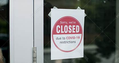 Closed due to Covid sign. Business owner places sign on storefront