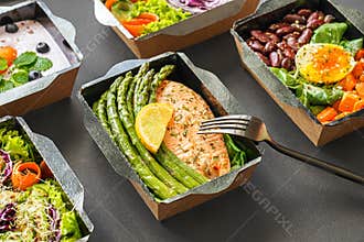 Ready healthy food menu meal delivery take away  boxes on black background.