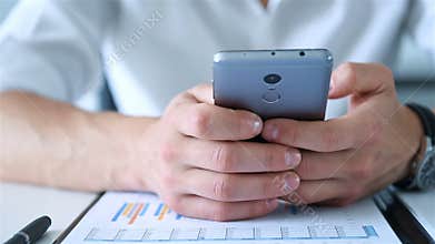 Stock Broker With Smart Phone Analyzing At Charts