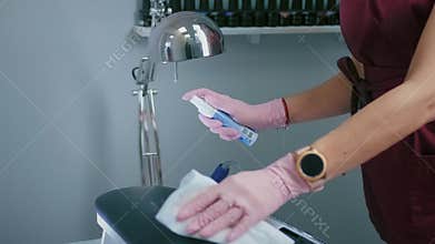 Woman is disinfecting table by disinfectant making sanitation against Covid-19.