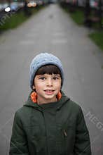 Portrait of a five-year-old boy in the city in the fall.
