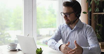 Confident skilled young salesman talking with client by video call.