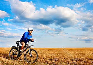 Young bright man on mountain bike