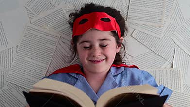 Superhero girl reading a book