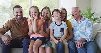 Portrait of six members of a multi-generation Caucasian family spending time at home together