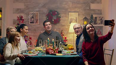 Teenage daughter taking a selfie with the family