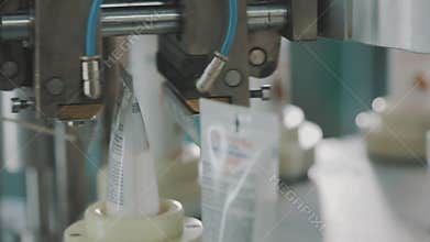 Production of cosmetic products. Cream production, modern automated conveyor.
