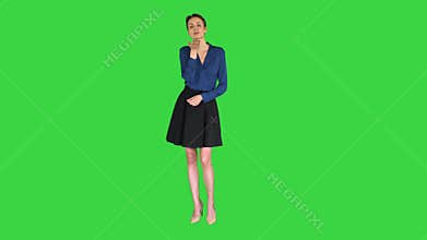 Short-haired girl blows a kiss to you on a Green Screen, Chroma Key.