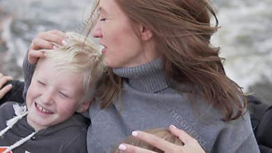 Happy Mom and son ride a speedboat on the river.