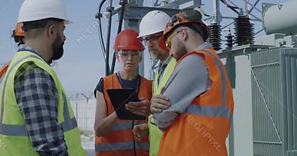 Foreman explaining data to employees on power plant