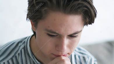 A young teenager is suffering. guy is crying. Adolescent problems. Awkward age.