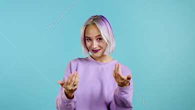 Beautiful woman showing - Hey you, come here. Girl in violet ask join her, beckons with inviting hand hugs gesture. Lady