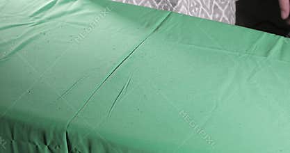 Male hands ironing clothes with iron on ironing board