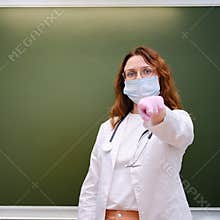 The school nurse stands at the blackboard and points a finger at you, copy space