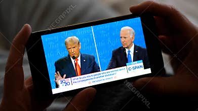 Los Angeles - 22 October 2020: Man Watching Trump vs Biden Presidential Debate on a Smartphone