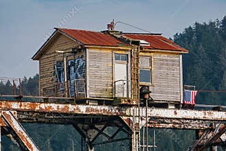 Bridge keepers station atop a swing span railroad bridge across the Siuslaw River near Florence, Oregon