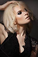 Fashion make-up. blond model in black dress