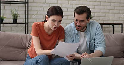 Couple sit on couch read paper letter celebrate great news