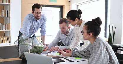 Multicultural coworkers group analyze paperwork at office team meeting