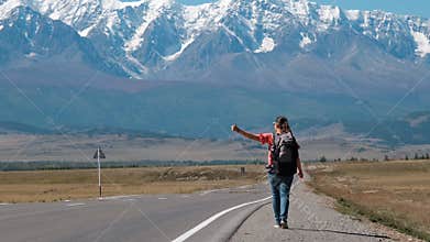 Woman Backpacking Hitchhiking on a Mountain Road