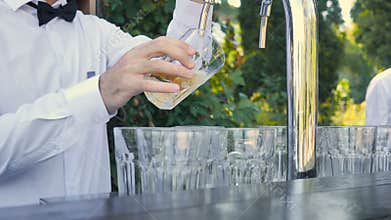 Beer is pouring into angled glass at oktoberfest festival
