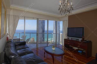 Living room view to ocean and city from top floor luxury apartment