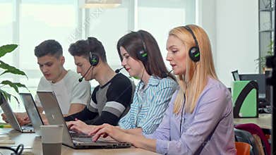 Beautiful young woman answering calls, working at customer support call center
