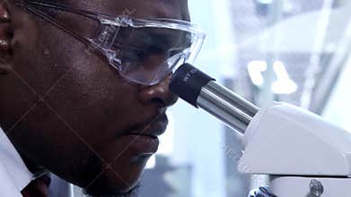 African-american scientist working in lab. Male doctor making microbiology research. Biotechnology, chemistry