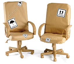 Office chairs all wrapped up in brown paper for a