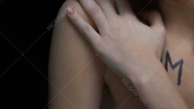 Scared female covering word victim written body, human trafficking, kidnapping