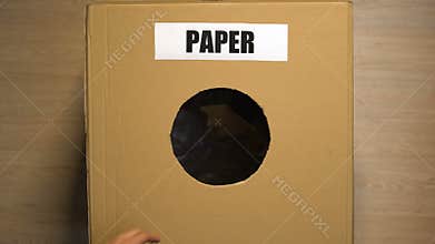 People putting paper trash in box collection cellulose waste, reusable materials