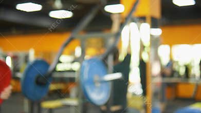 Blur background. barbells in the gym. Blurred fitness room with weight training bar