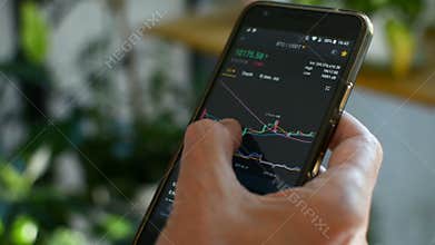 Bitcoin market, crypto trading online, trader working with a mobile phone on cryptocurrency exchange. Man touching