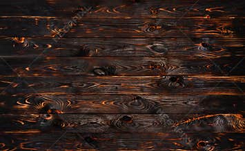 Burnt wooden board, black charcoal wood texture, burned barbecue background