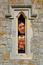 Prison cell faces looking through fort window