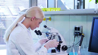 Female scientist working in modern lab. Doctor making microbiology research. Biotechnology, chemistry, bacteriology