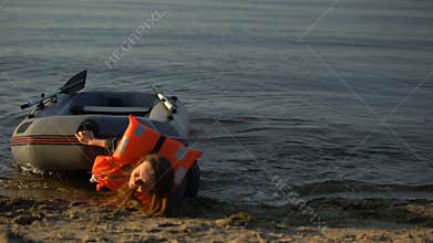 Biracial girl pulling boat, exhausted falling on sand, catastrophe survivor